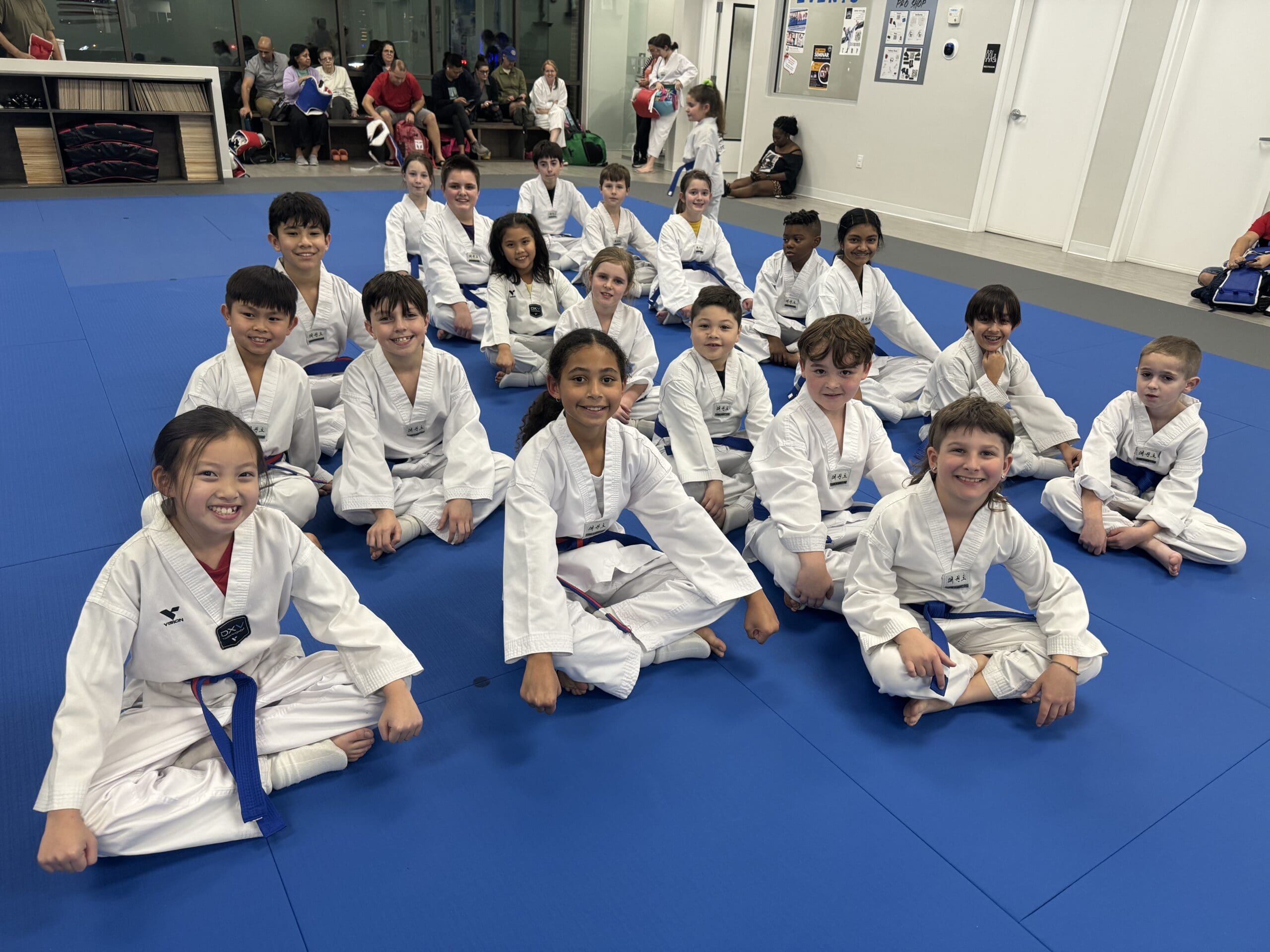 Kids' self-defense training teaches them physical techniques, situational awareness, and critical thinking skills to effectively handle and escape potential threats.