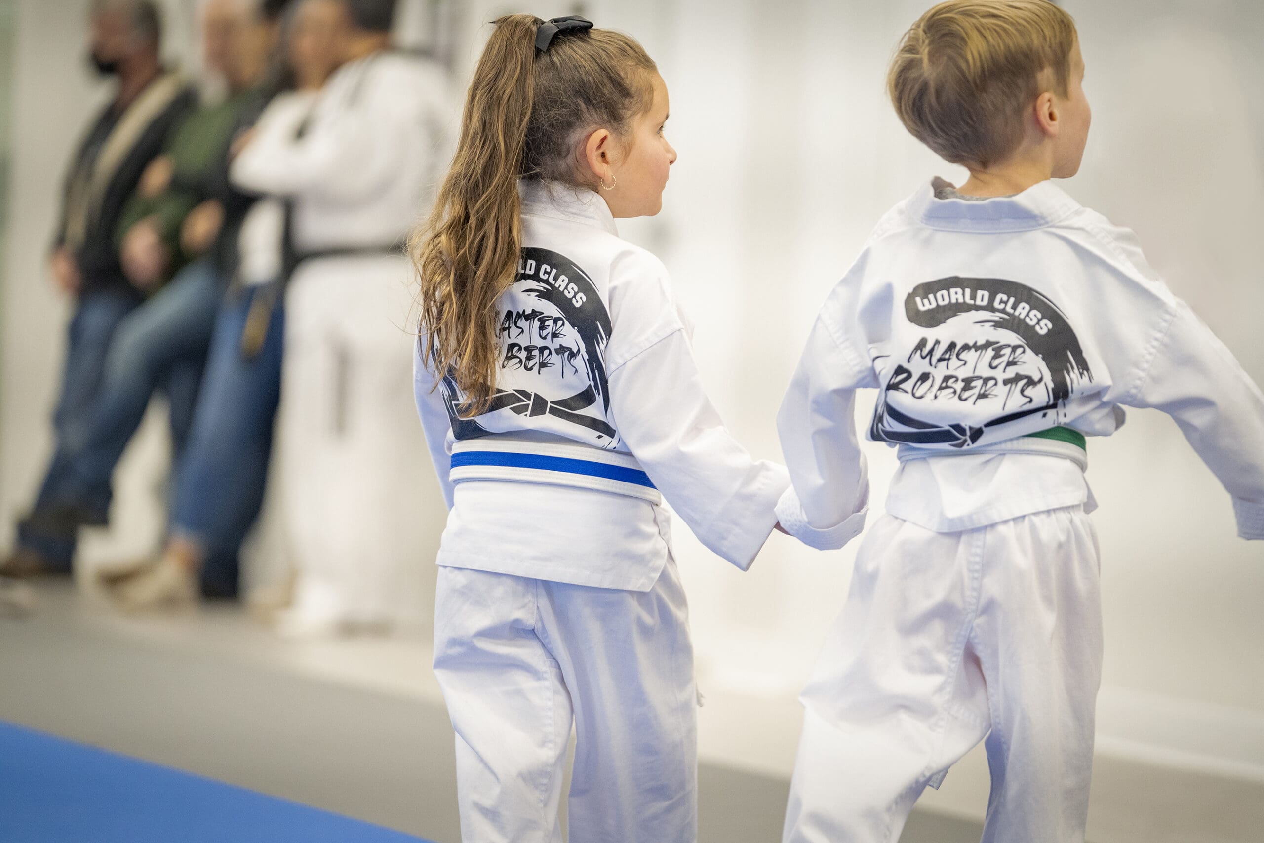 Korean martial arts, such as preschool Taekwondo training, help young children develop self-defense skills, physical fitness, motor skills, and valuable life skills, while experienced instructors guide them through training sessions that enhance self-esteem, cognitive abilities, mental benefits, improved fitness, mutual respect, and even academic performance.