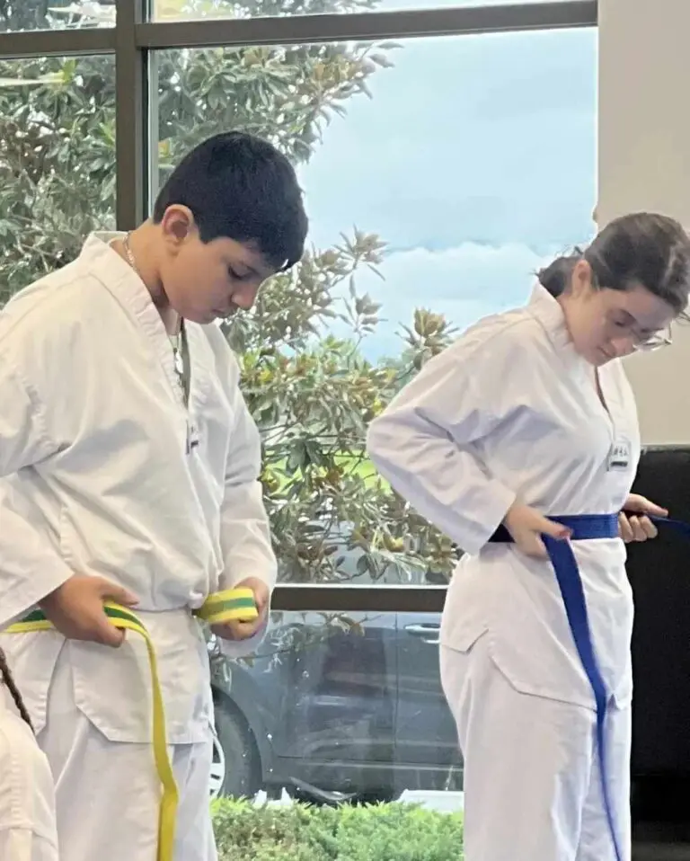 teens fixing martial arts belt in a class