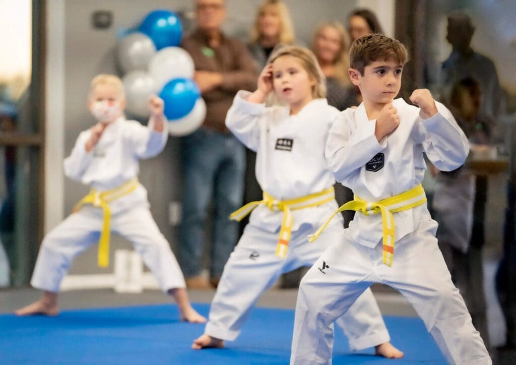 Young students holding guard stance during beginner taekwondo training