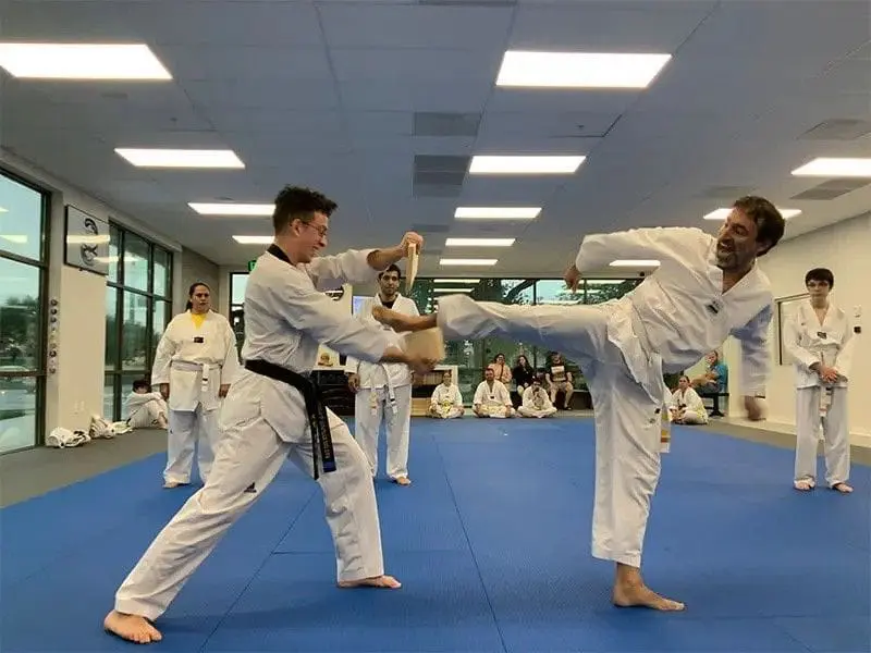 students practicing kicks for adult self defense class