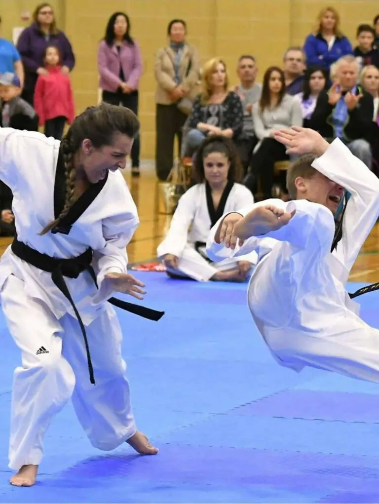 Adult martial arts student performing a takedown on a partner during a live demonstration in front of spectators, what happens in an adult martial arts class